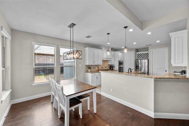 dining room with dark hardwood / wood-style flooring and sink