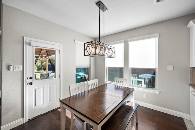 dining room with a chandelier and dark hardwood / wood-style flooring