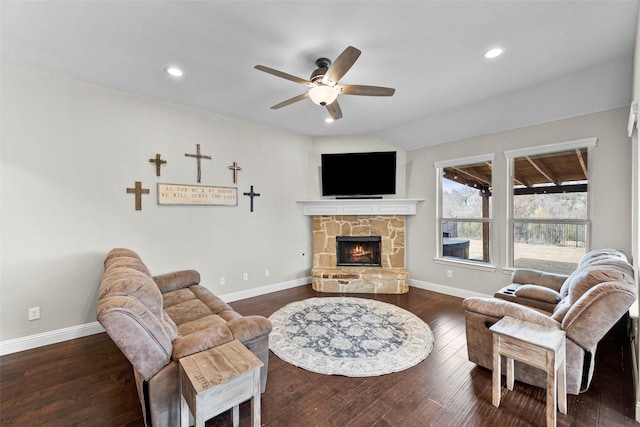 living room featuring ceiling fan, lofted ceiling, dark hardwood / wood-style floors, and a fireplace