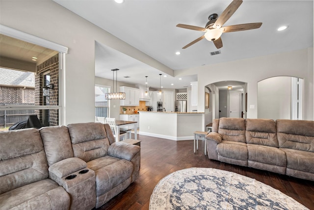 living room featuring dark hardwood / wood-style floors and ceiling fan