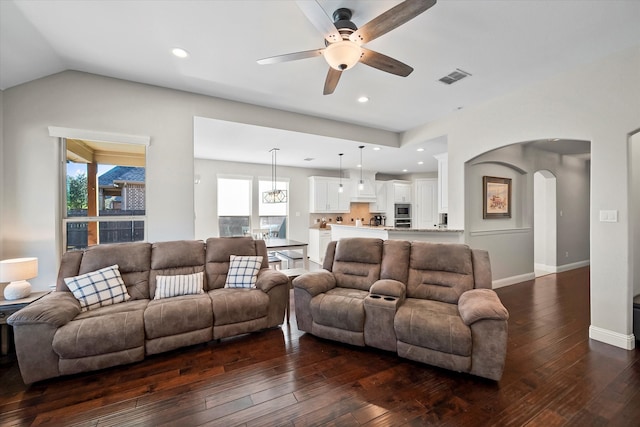 living room featuring ceiling fan, lofted ceiling, and dark hardwood / wood-style floors