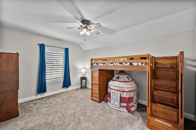 bedroom with ceiling fan, lofted ceiling, and carpet