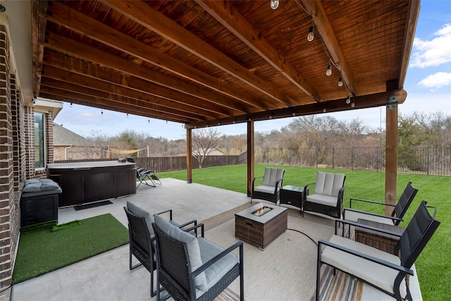 view of patio featuring a hot tub and a fire pit