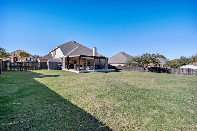 view of yard featuring a storage unit and a patio