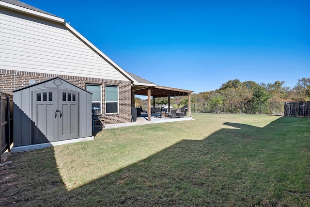 view of yard featuring a shed and a patio area