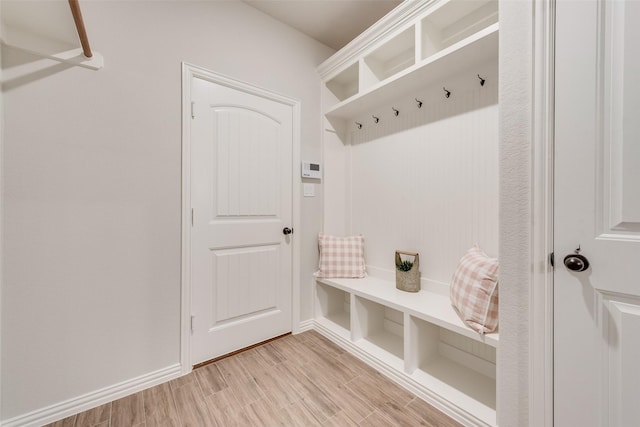 mudroom featuring baseboards and light wood finished floors