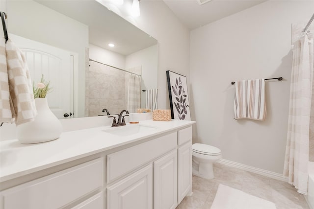 bathroom with tile patterned floors, toilet, vanity, and baseboards