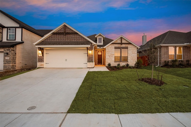 view of front facade with a garage, stone siding, a lawn, and concrete driveway