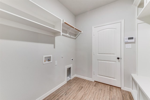 washroom featuring electric dryer hookup, light wood-type flooring, gas dryer hookup, hookup for a washing machine, and laundry area