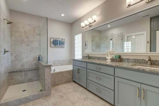 bathroom with vanity and shower with separate bathtub