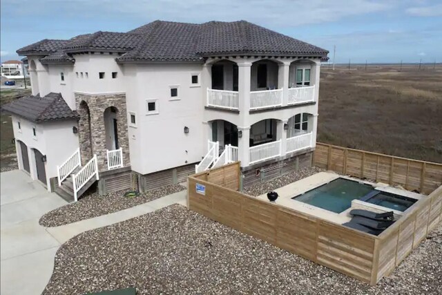 rear view of house featuring a balcony