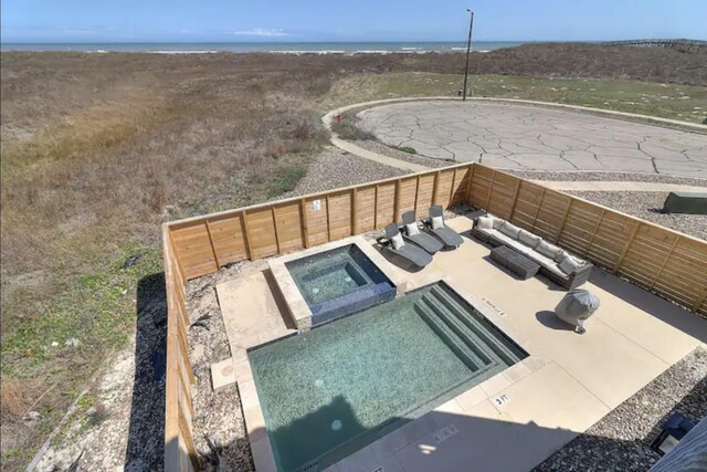 view of pool with outdoor lounge area, a patio area, and an in ground hot tub