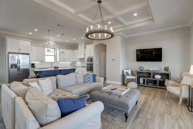 living room with light wood-type flooring, coffered ceiling, crown molding, beam ceiling, and an inviting chandelier