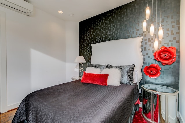 bedroom featuring an AC wall unit and wood-type flooring