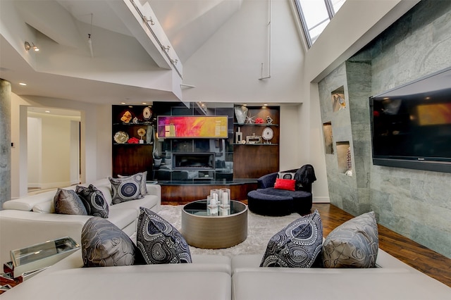 living room with hardwood / wood-style flooring and high vaulted ceiling