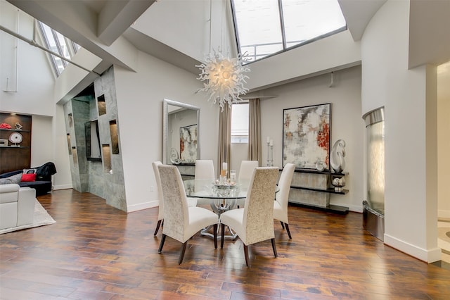 dining space featuring dark hardwood / wood-style floors, high vaulted ceiling, and a chandelier