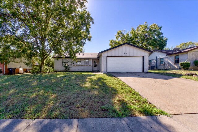 ranch-style home featuring a front yard and a garage