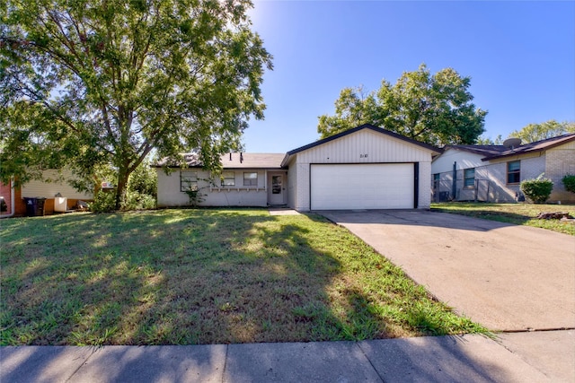 single story home featuring a garage and a front lawn