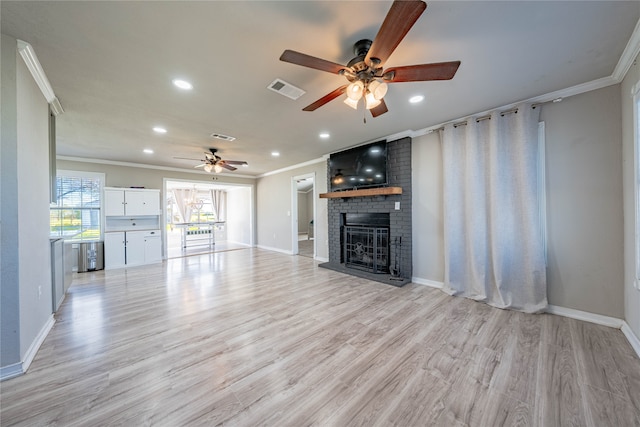 unfurnished living room featuring a fireplace, light wood-type flooring, ceiling fan, and ornamental molding