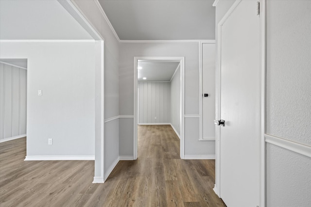 hall featuring hardwood / wood-style floors and ornamental molding