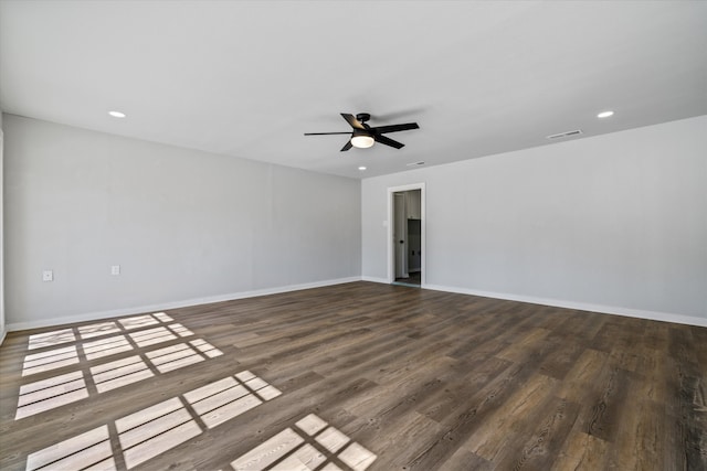 empty room with ceiling fan and dark wood-type flooring