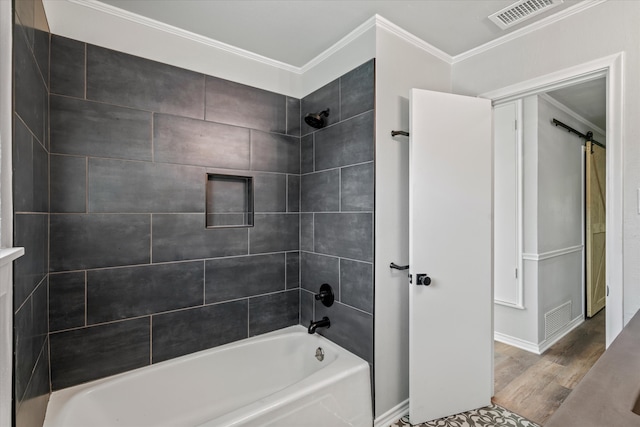 bathroom featuring crown molding, hardwood / wood-style floors, and tiled shower / bath combo