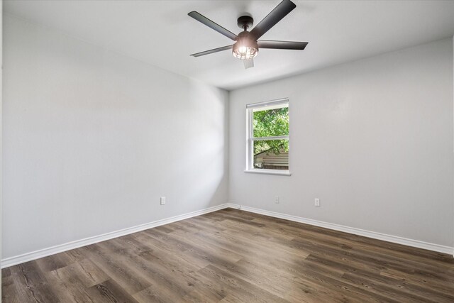 spare room featuring ceiling fan and dark wood-type flooring