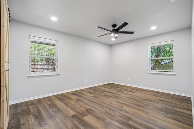 empty room featuring ceiling fan and dark hardwood / wood-style flooring