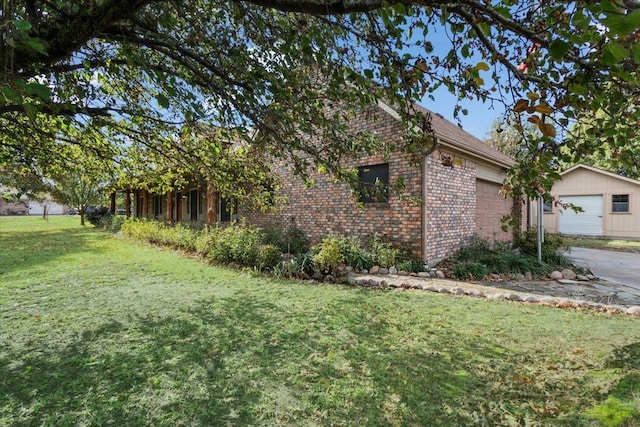 view of home's exterior featuring a garage and a lawn