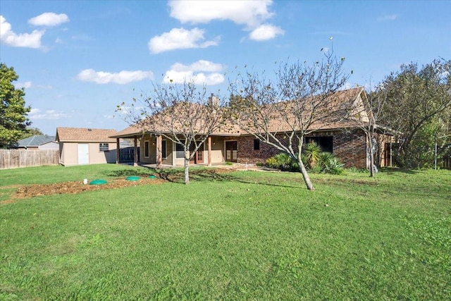 rear view of house featuring a patio and a lawn