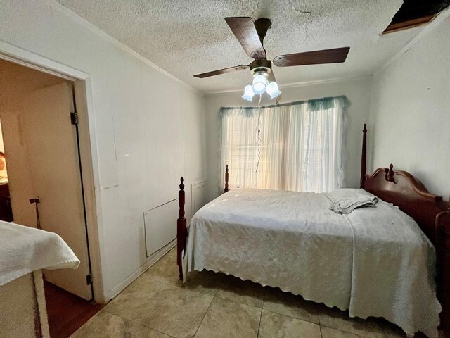 tiled bedroom with radiator, a textured ceiling, ceiling fan, and crown molding