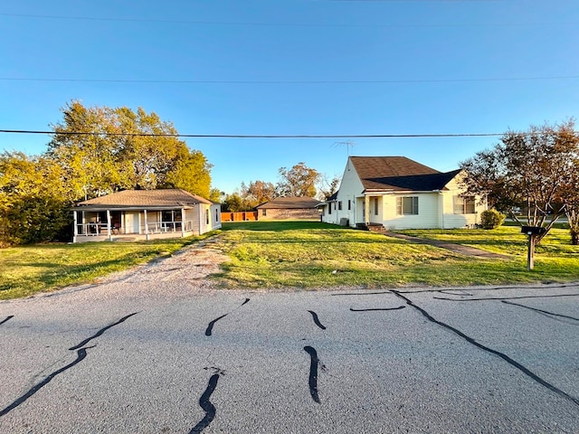 view of front of home featuring covered porch and a front yard