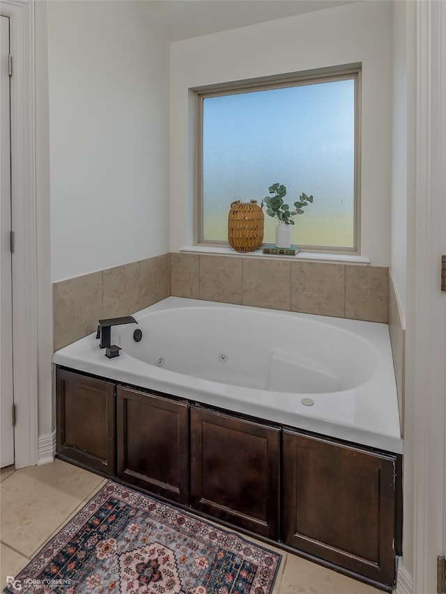 bathroom featuring tile patterned flooring and a bath