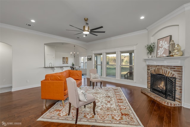 living room with a fireplace, wood-type flooring, and crown molding