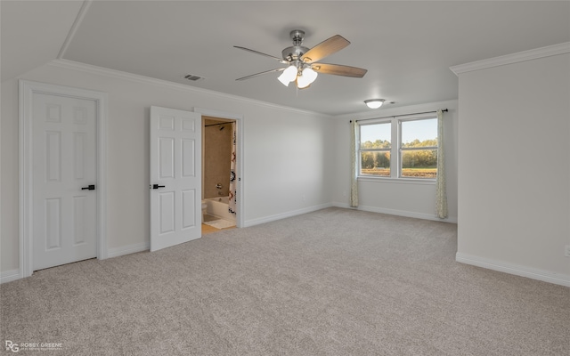 carpeted empty room featuring ceiling fan and ornamental molding