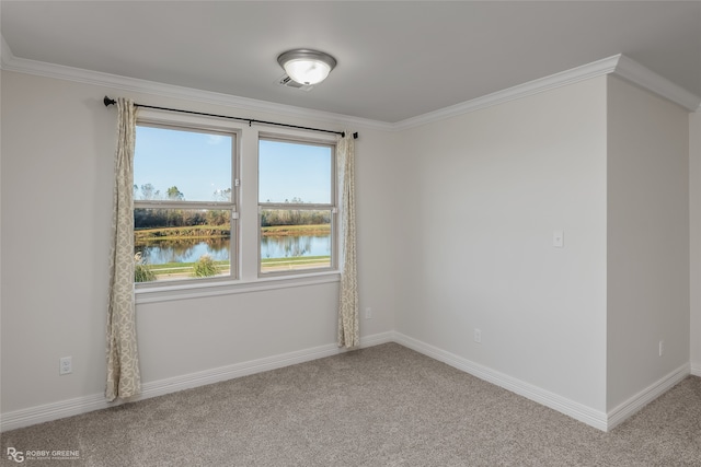 carpeted spare room with crown molding and a water view