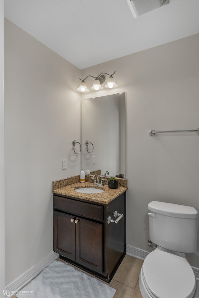 bathroom featuring tile patterned floors, vanity, and toilet