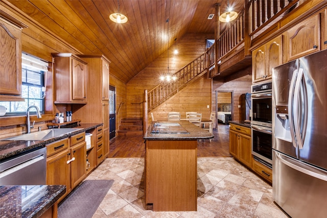 kitchen with sink, stainless steel appliances, vaulted ceiling, a kitchen island, and wood ceiling