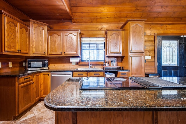 kitchen with appliances with stainless steel finishes, sink, dark stone countertops, and wooden ceiling