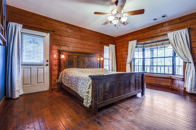 bathroom with a shower, wooden walls, and vanity