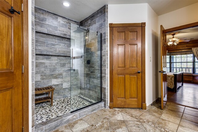 bathroom featuring tiled shower, vanity, and toilet