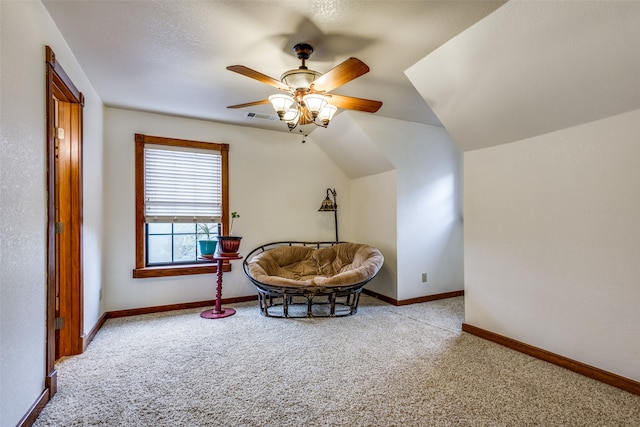 sitting room with ceiling fan, light colored carpet, and lofted ceiling