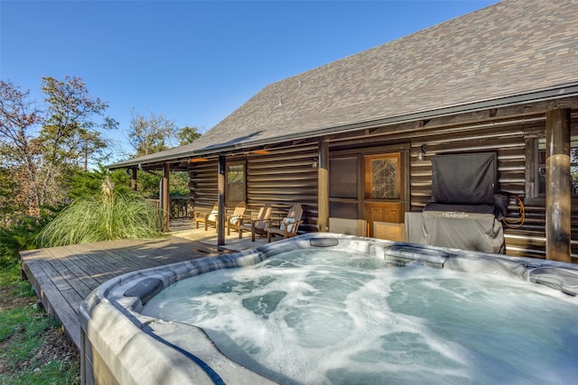 view of patio featuring a wooden deck and a hot tub