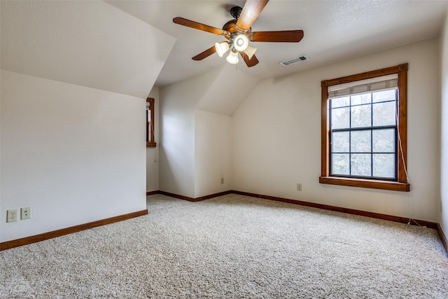 bonus room featuring lofted ceiling, carpet floors, and ceiling fan