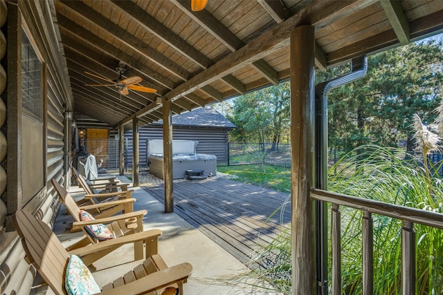 deck featuring ceiling fan and a hot tub