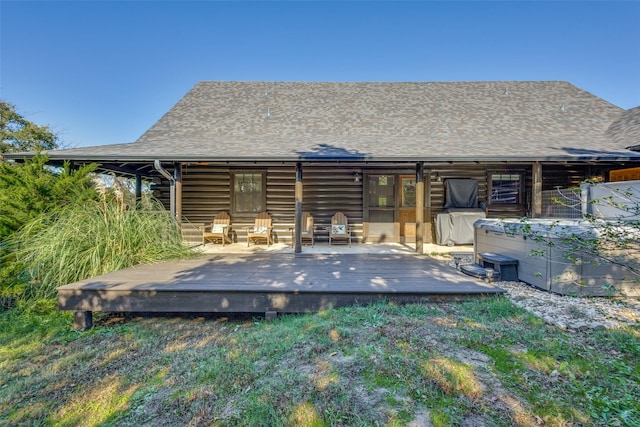 rear view of house featuring a wooden deck