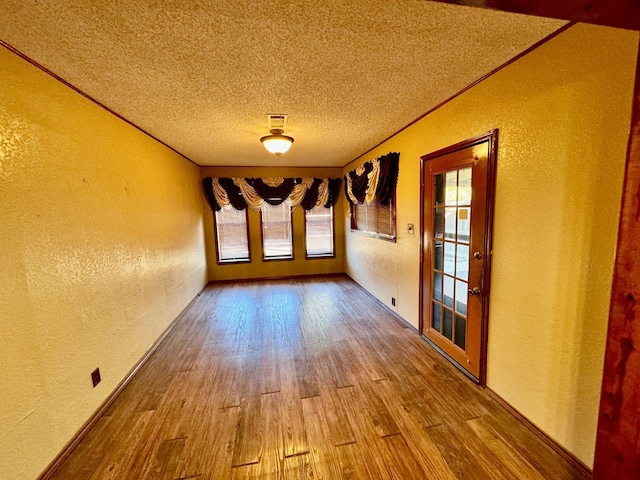 interior space featuring hardwood / wood-style floors and a textured ceiling