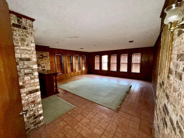 interior space with tile patterned flooring and a textured ceiling