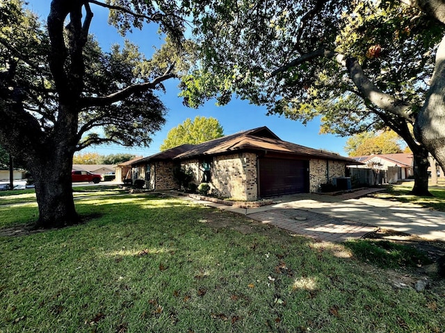 view of side of home featuring a garage and a yard