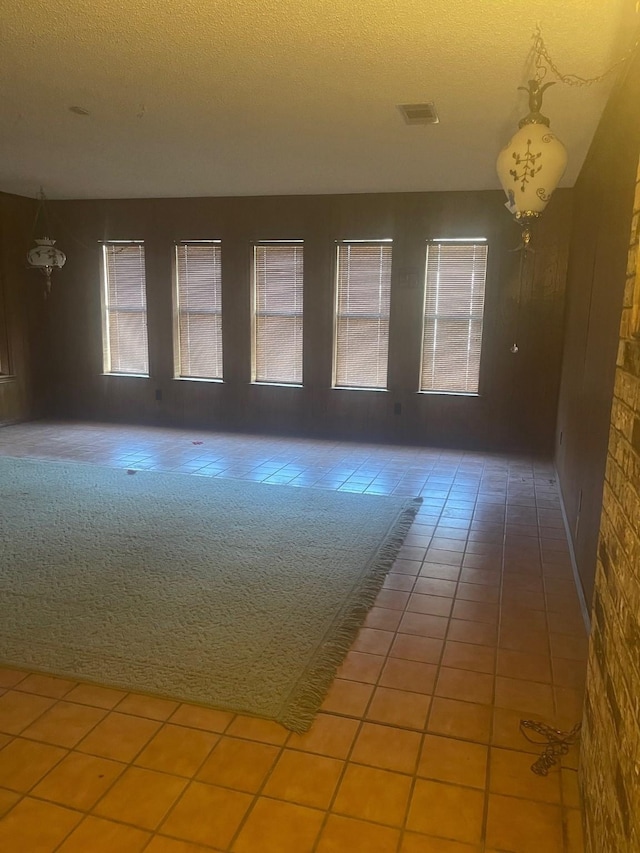 empty room with carpet and a textured ceiling